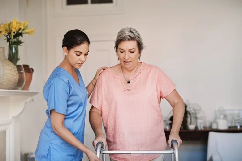 Nurse helping woman with walker